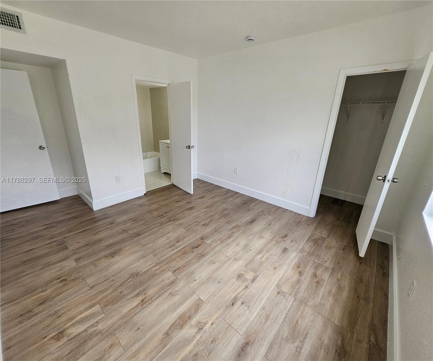 450 Northwest 84th Street, Unit 450 Miami, FL 33150 - Photo 24 of 28 wooden floor in an empty room