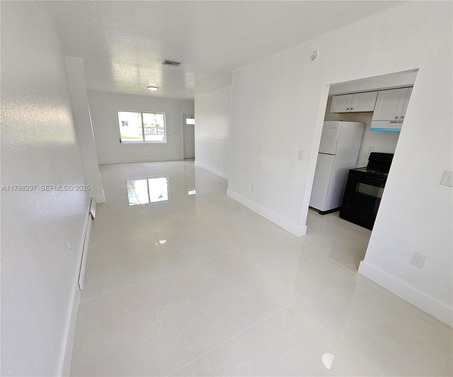 450 Northwest 84th Street, Unit 450 Miami, FL 33150 - Photo 3 of 28 a view of an empty room with a window