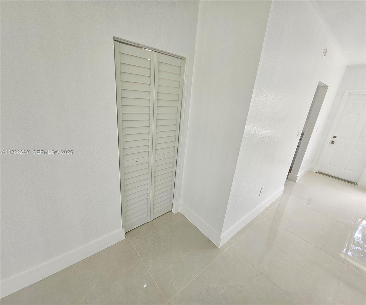 450 Northwest 84th Street, Unit 450 Miami, FL 33150 - Photo 6 of 28 an empty room with a bench