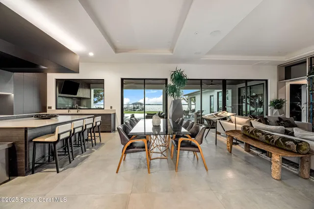 a kitchen with stainless steel appliances kitchen island granite countertop a table and chairs