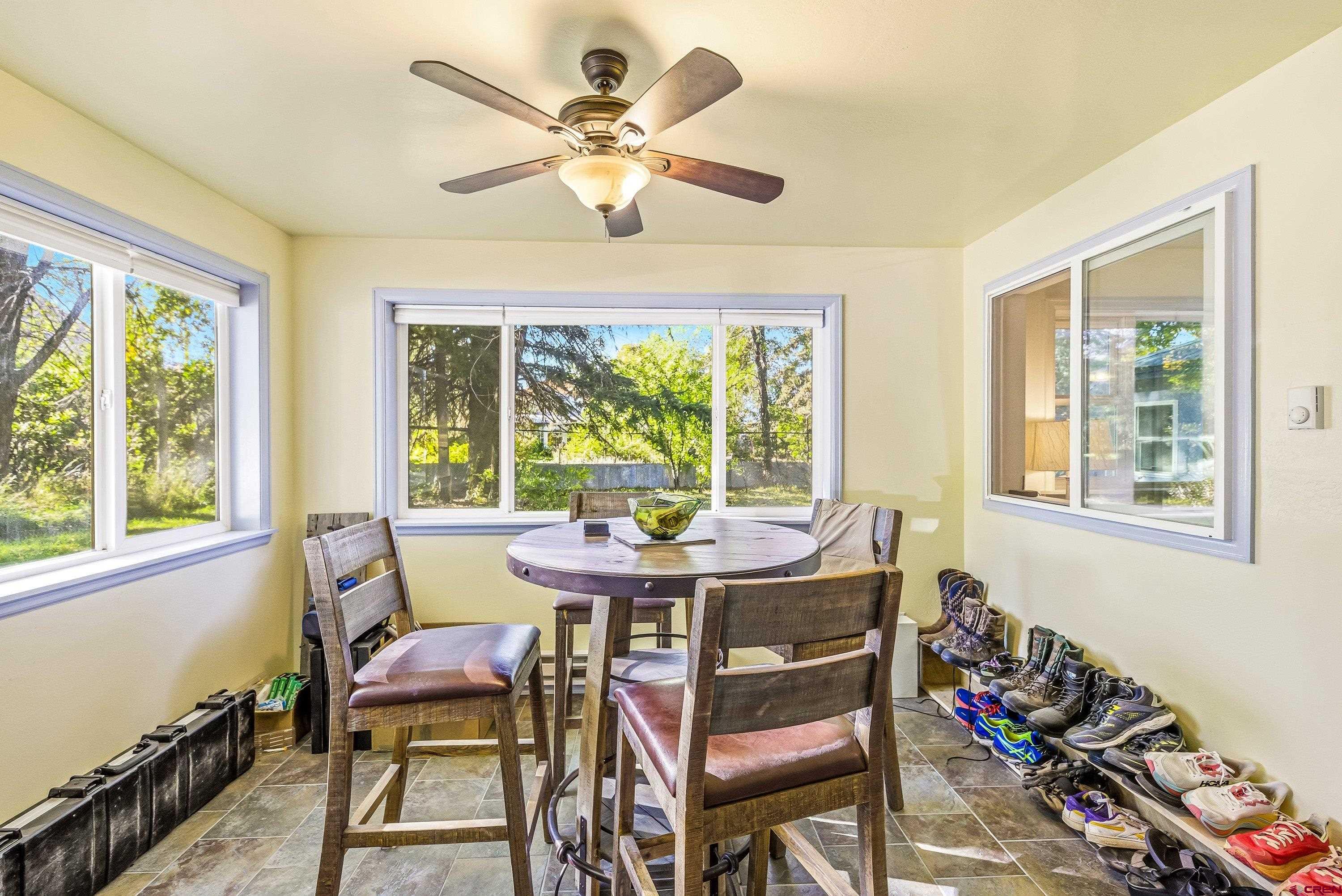 16459 Grange Road Paonia, CO 81428 - Photo 4 of 31 a dining room with furniture a rug and a large window