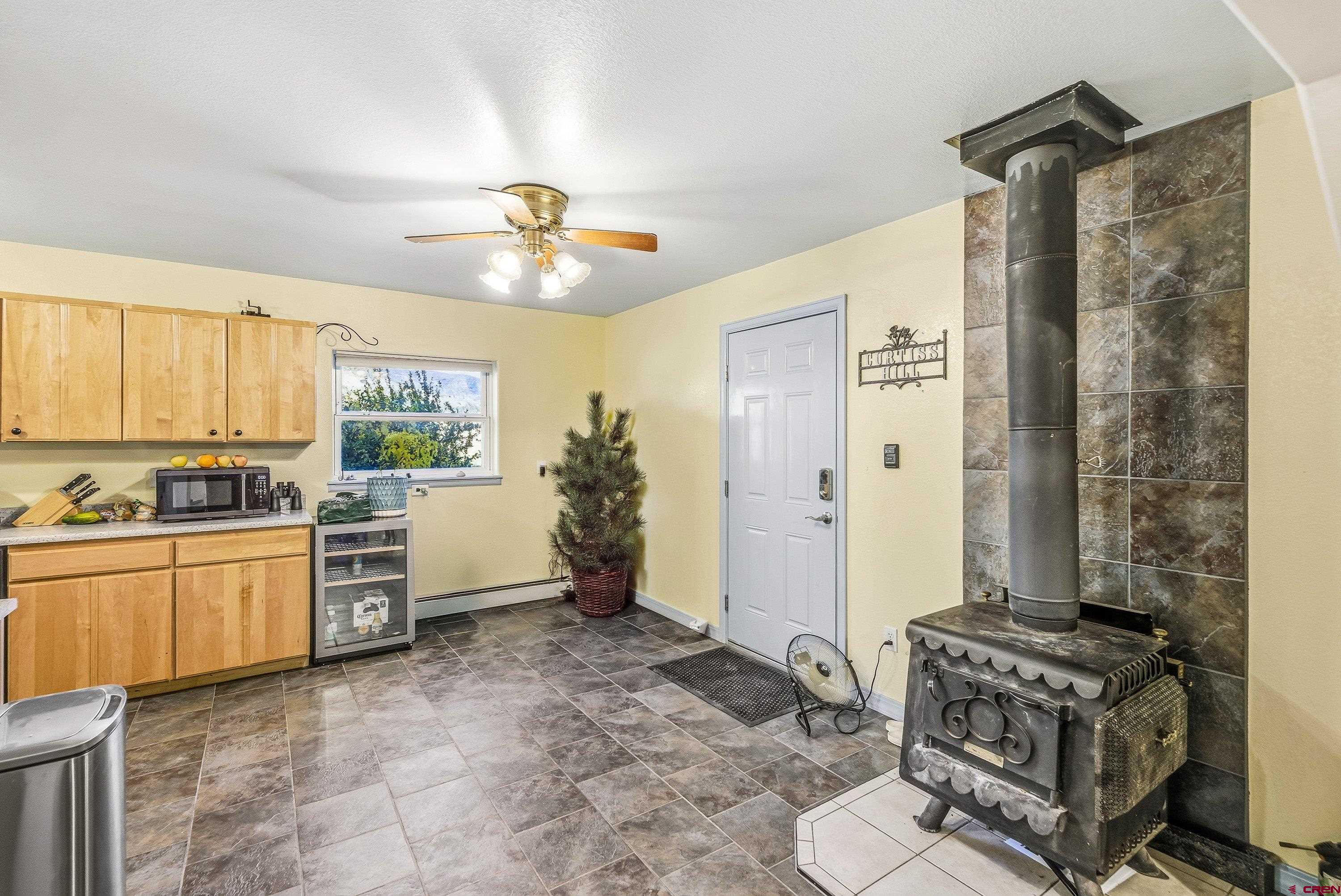 16459 Grange Road Paonia, CO 81428 - Photo 5 of 31 a kitchen with stainless steel appliances granite countertop a stove a sink and a refrigerator