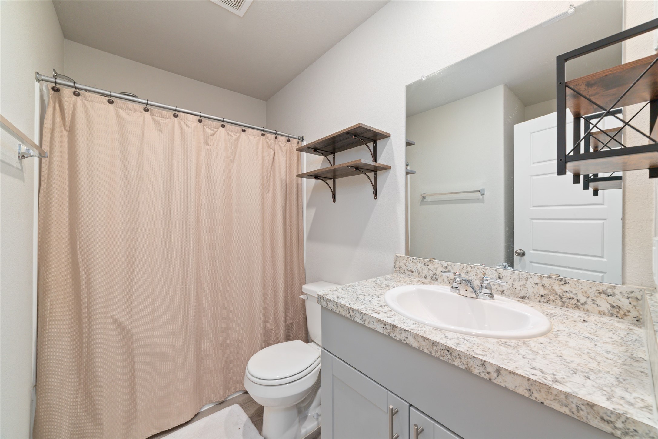 14232 Shasta Ridge Drive Conroe, TX 77303 - Photo 19 of 26 Clean secondary bathroom with bright lighting and a spacious vanity, creating a fresh and open feel.