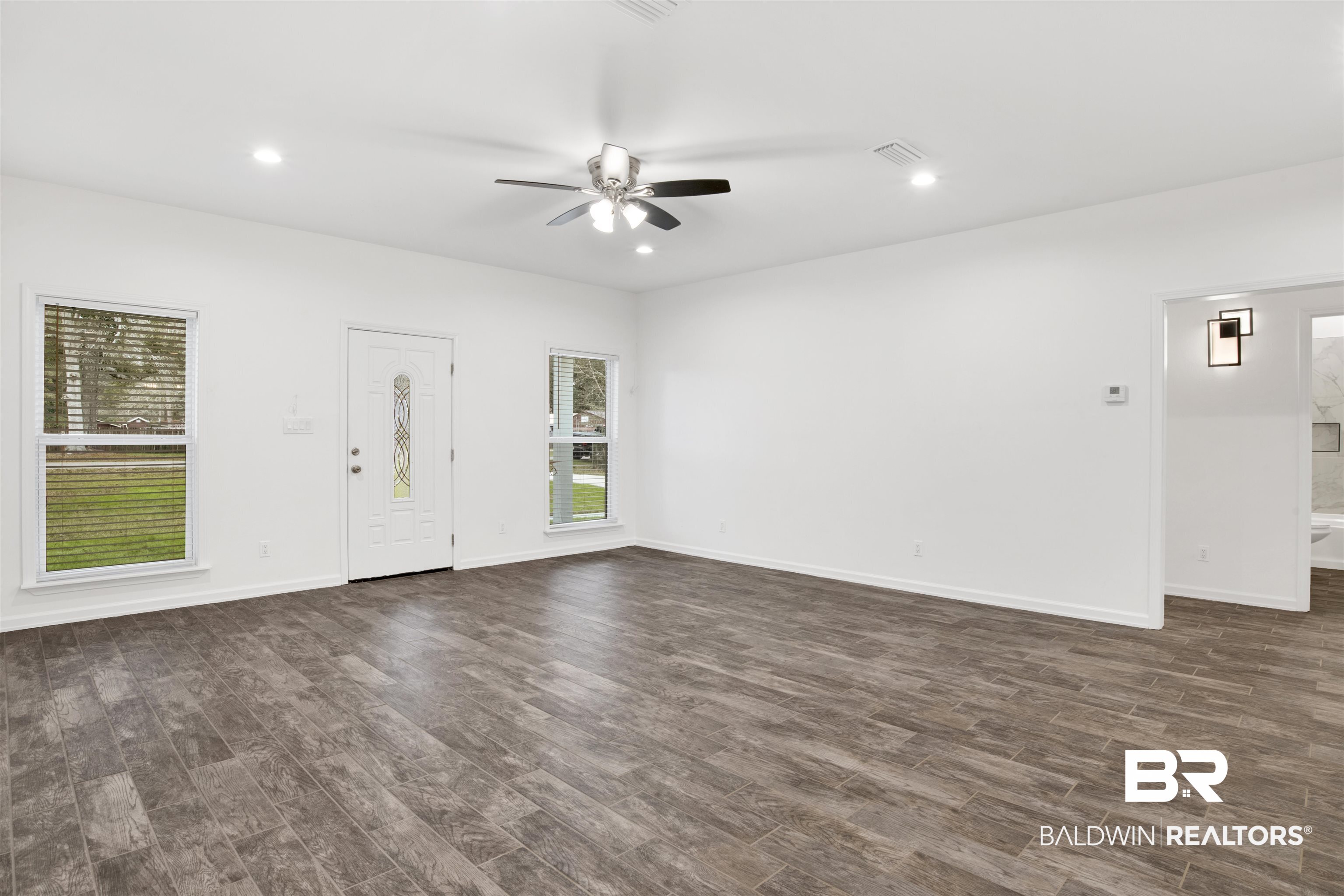 10871 Somerset Road Grand Bay, AL 36541 - Photo 16 of 31 Unfurnished living room with ceiling fan and dark hardwood / wood-style floors