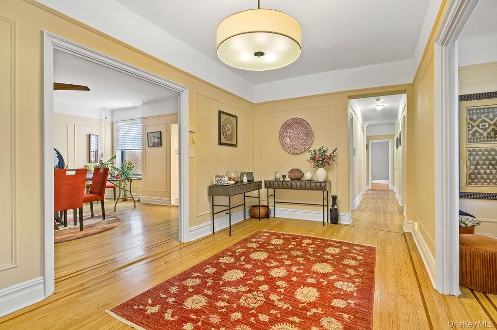 43 Calton Road, Unit 5C New Rochelle, NY 10804 - Photo 6 of 32 Corridor featuring light wood-style floors and a decorative wall