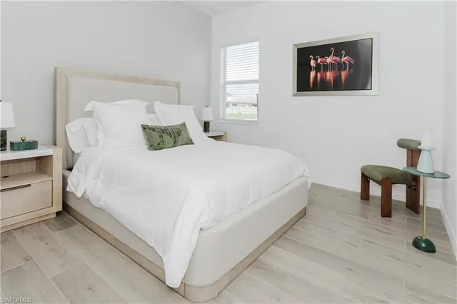 a bedroom with a bed and a painting on the wall