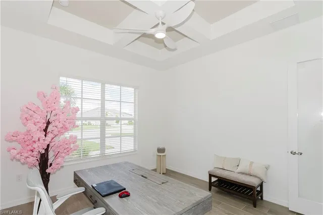 a living room with furniture and a large window with balcony view