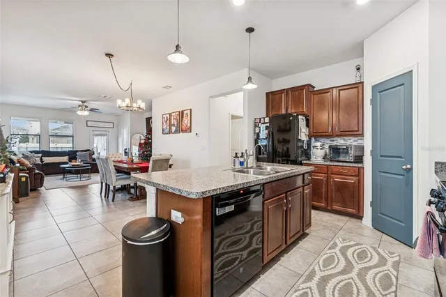 a kitchen with stainless steel appliances granite countertop a sink a stove and a refrigerator