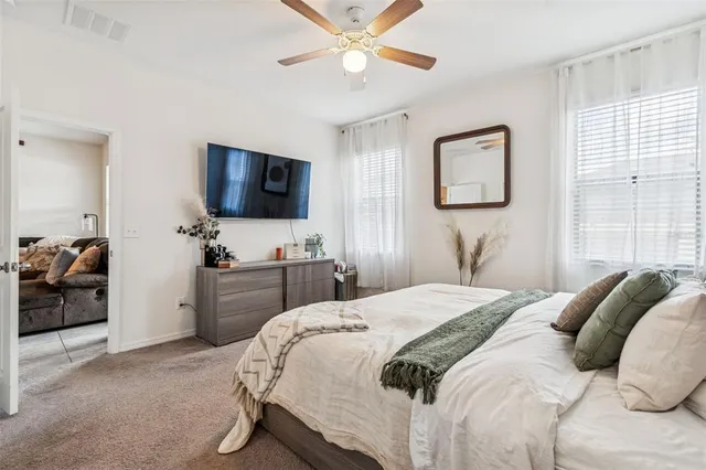 a bedroom with a bed and a flat screen tv