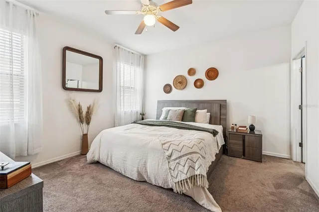 a bedroom with a bed and painting on the wall