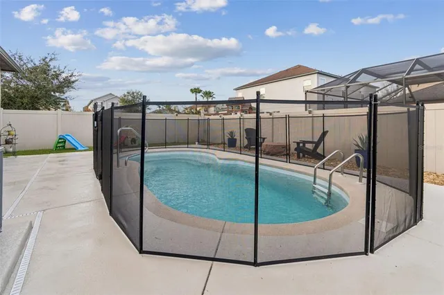 a swimming pool with outdoor seating and yard