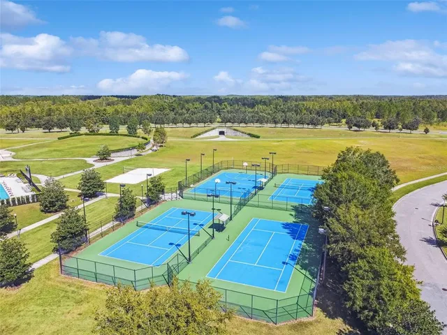 an aerial view of a swimming pool with an outdoor seating