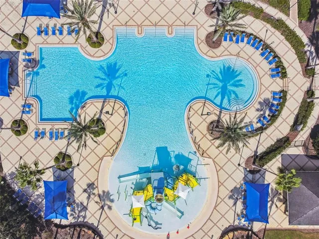 a swimming pool with outdoor seating and yard