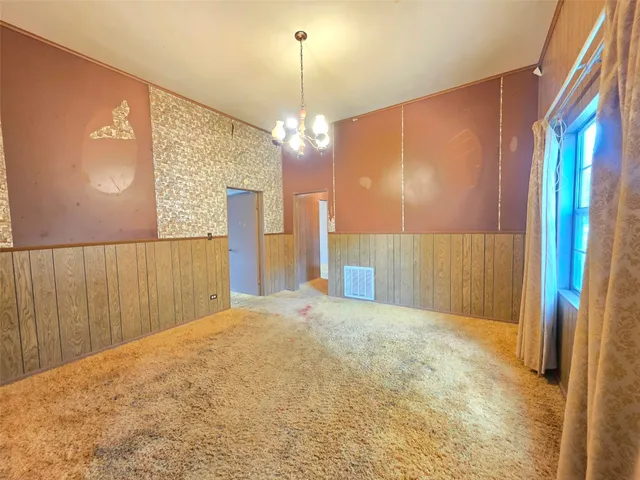 a view of a hallway with a chandelier