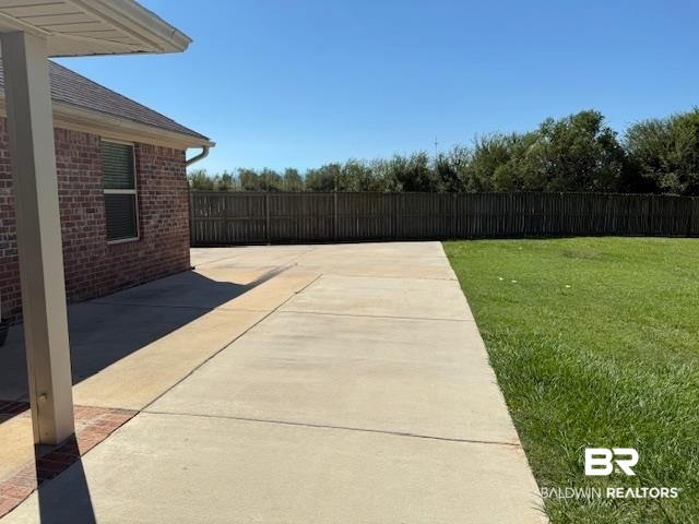 15577 Talus Court Foley, AL 36535 - Photo 21 of 28 Fenced backyard with a patio area