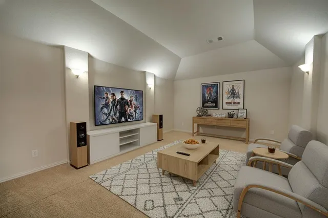 a living room with furniture and painting on the wall