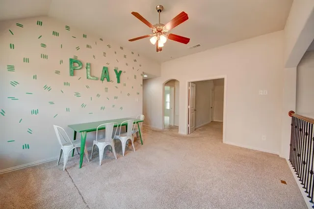 a view of a livingroom with furniture and a ceiling fan