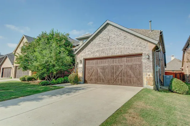 a front view of house with yard and trees