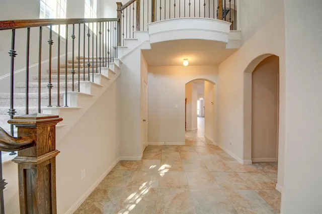 a view of a hallway with wooden floor and entryway