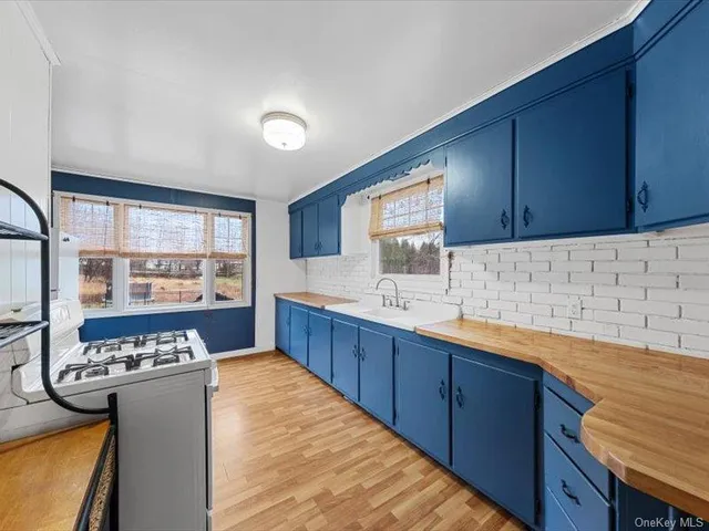 a kitchen with lots of counter top space and sink