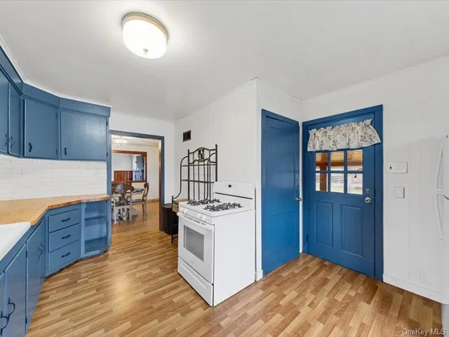 a kitchen with granite countertop a stove and a refrigerator