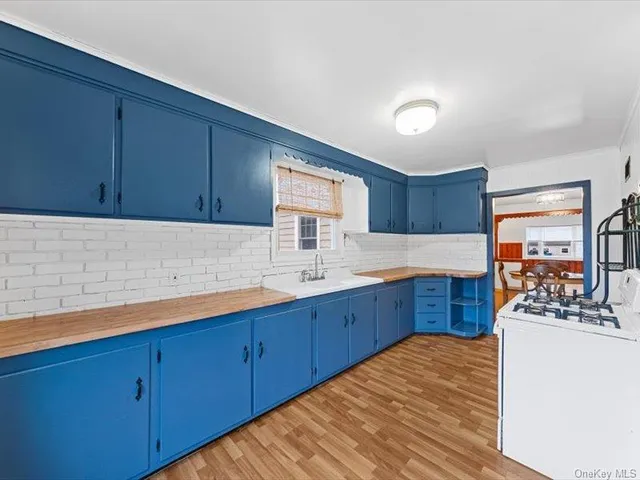 a kitchen with wooden cabinets and sink