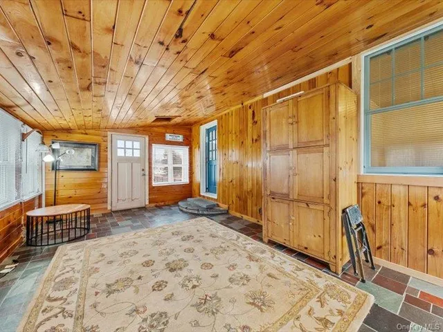 a view of a bedroom with wooden floor and a window