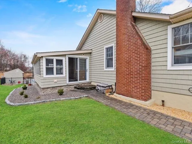 a backyard of a house with table and chairs