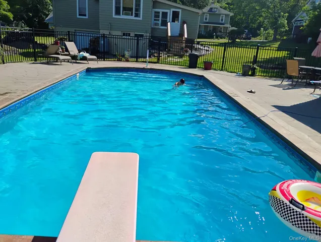 swimming pool view with a outdoor seating