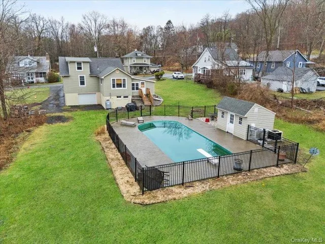 a view of a house with a big yard and sitting area
