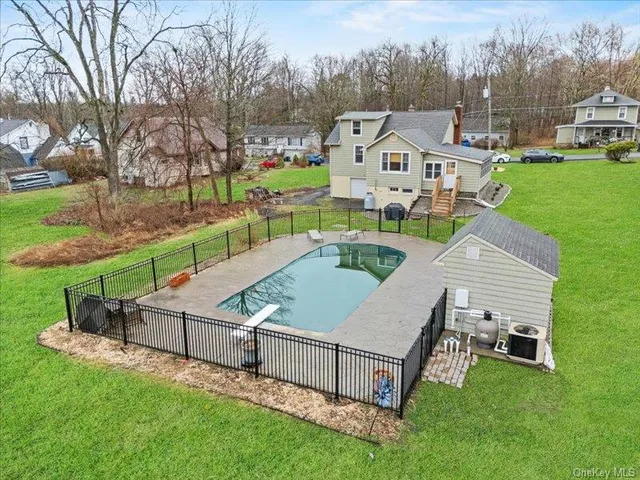 a view of a house with a yard and sitting area