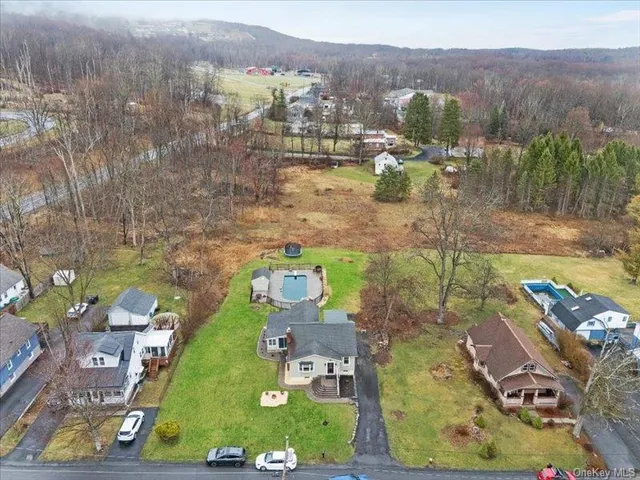 an aerial view of a house with a swimming pool