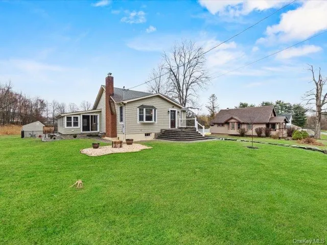 a aerial view of a house with swimming pool garden and trees