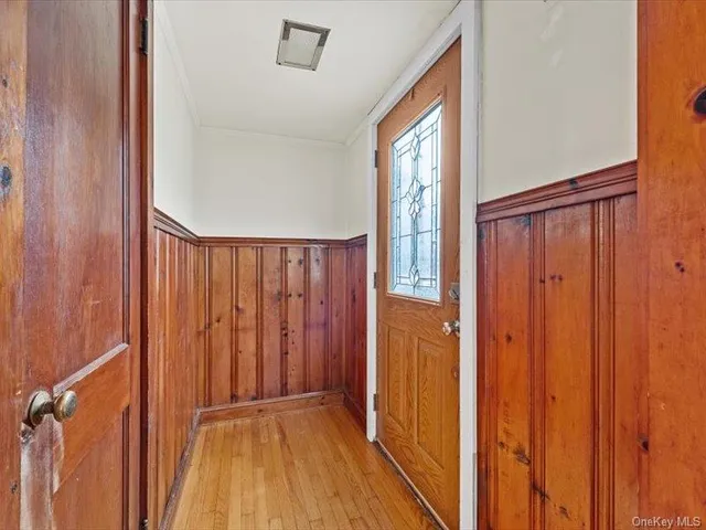 a view of a hallway with wooden floor and closet