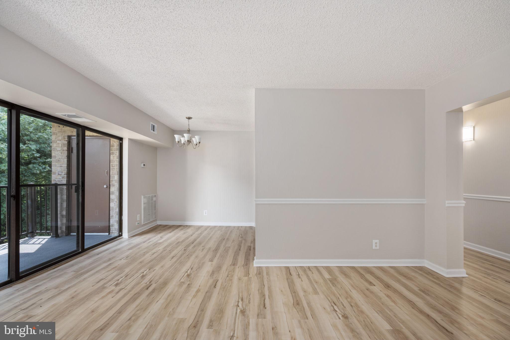 11659 Stoneview Square, Unit 11C Reston, VA 20191 - Photo 16 of 50 wooden floor in an empty room with a window