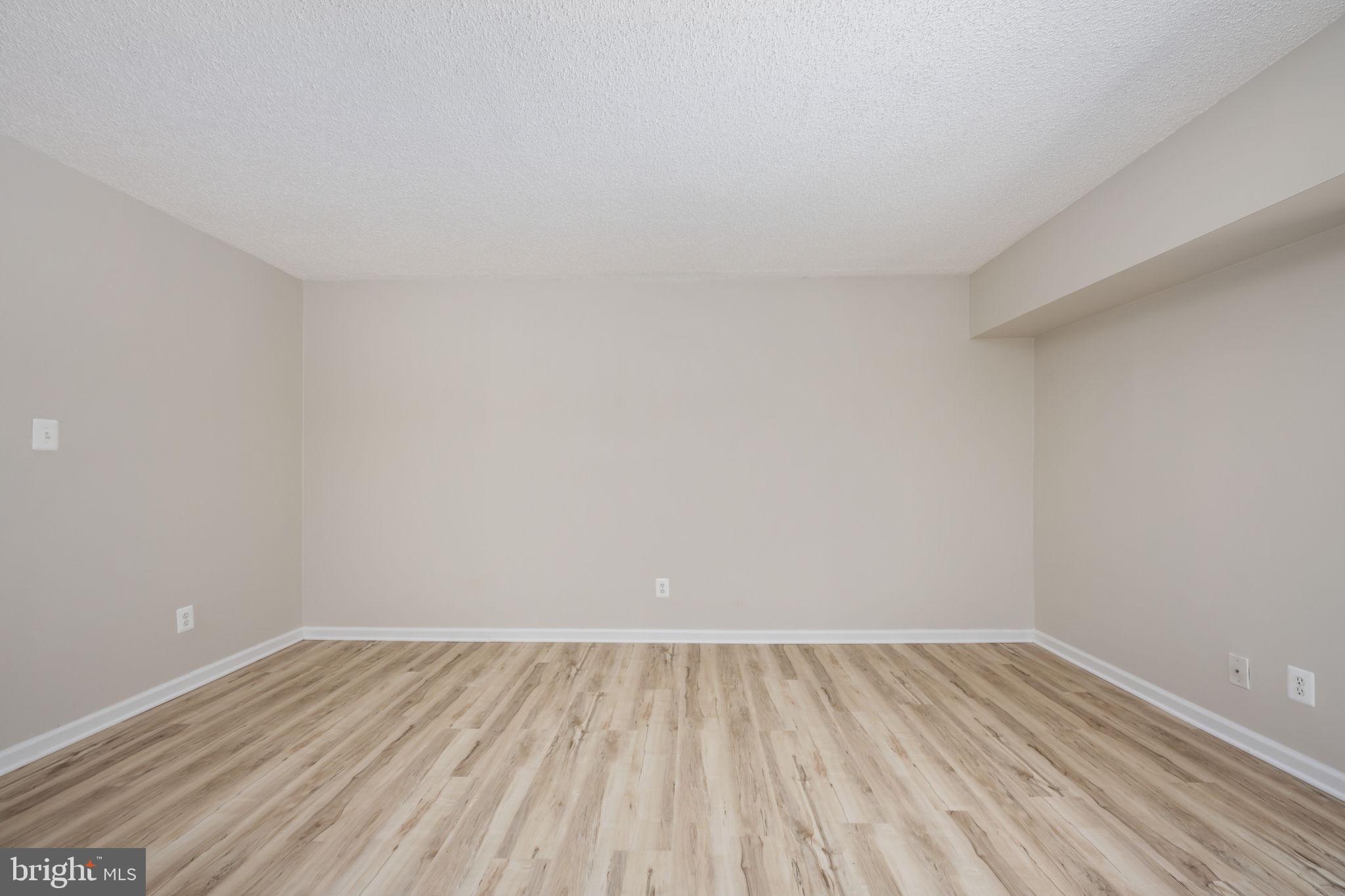 11659 Stoneview Square, Unit 11C Reston, VA 20191 - Photo 18 of 50 a view of an empty room and wooden floor