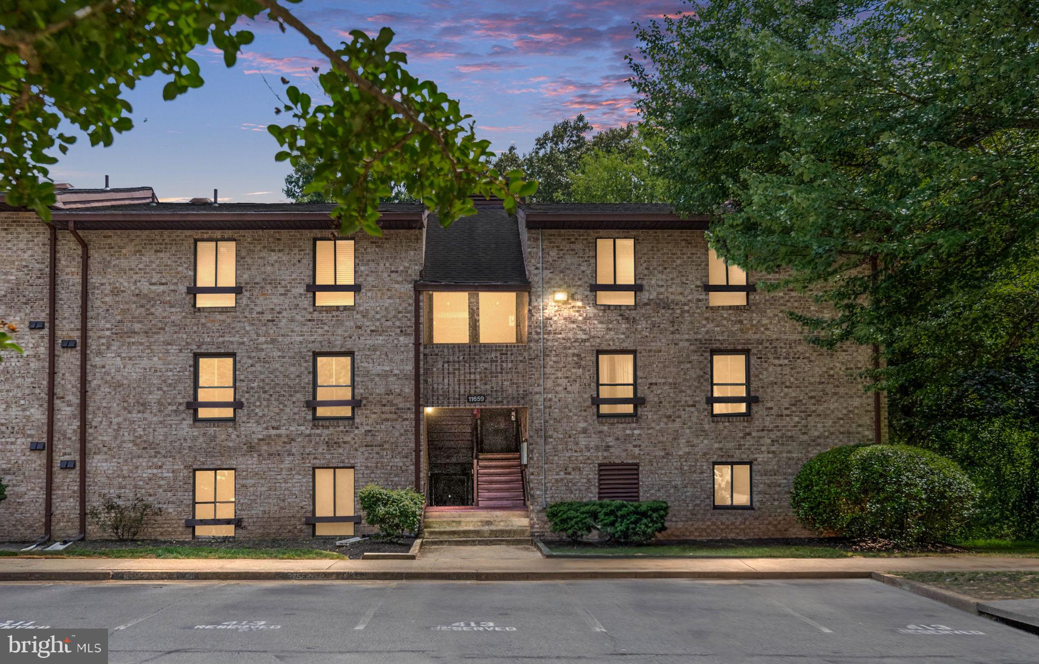 11659 Stoneview Square, Unit 11C Reston, VA 20191 - Photo 2 of 50 a front view of a house with a yard