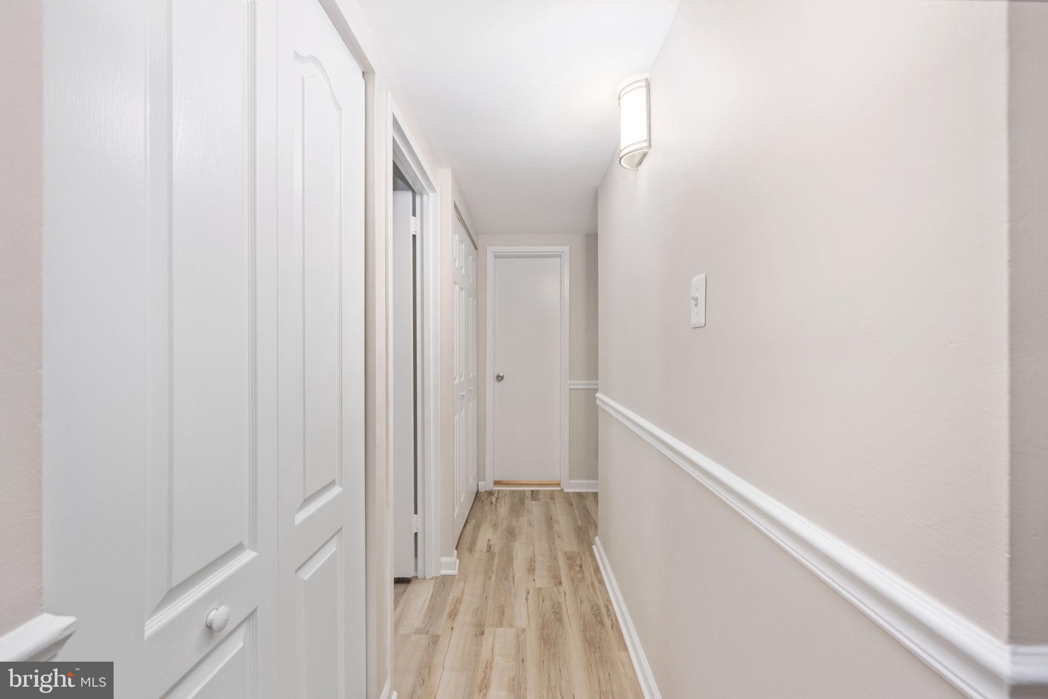 11659 Stoneview Square, Unit 11C Reston, VA 20191 - Photo 22 of 50 a view of a hallway with wooden floor and entryway