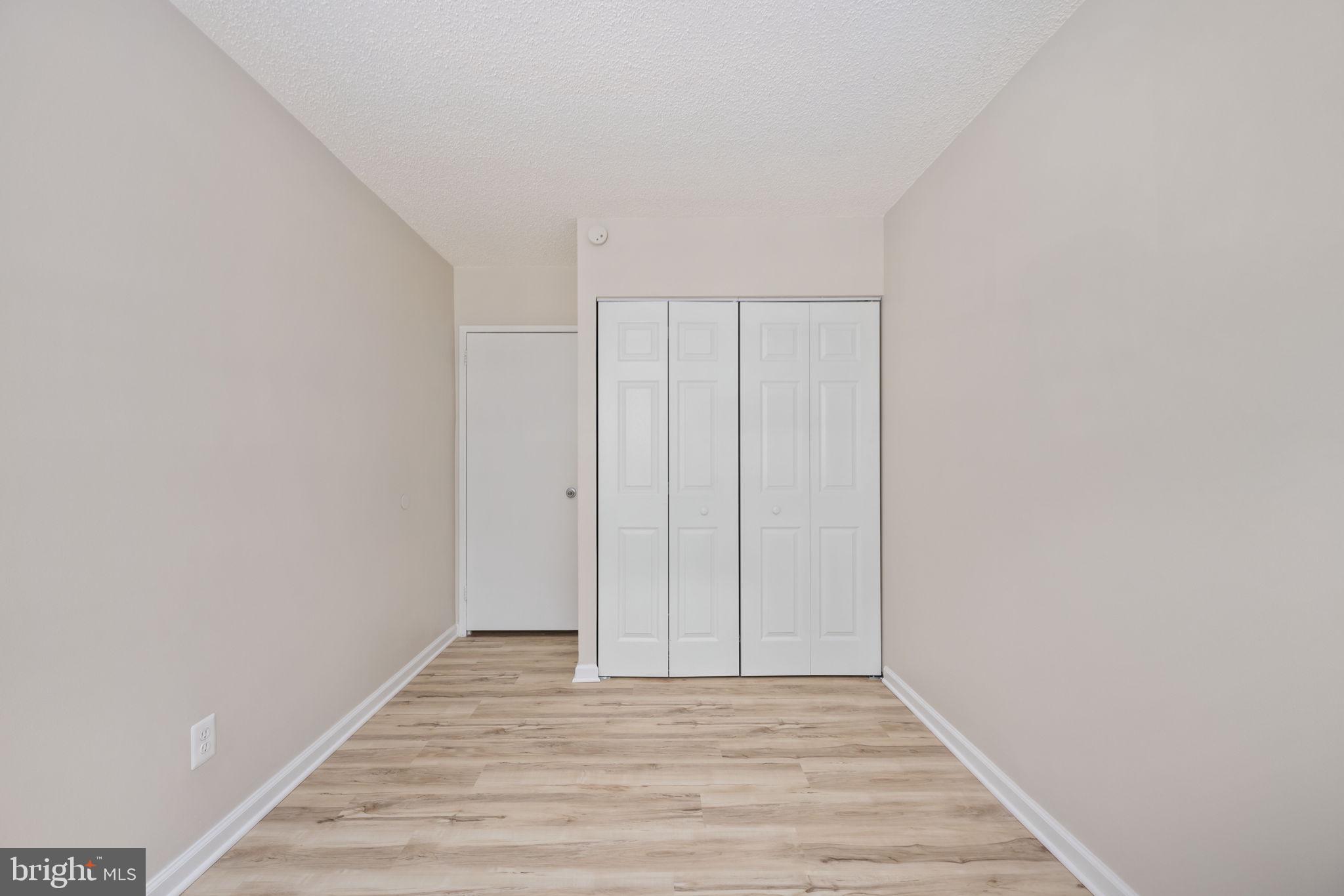 11659 Stoneview Square, Unit 11C Reston, VA 20191 - Photo 25 of 50 a view of an empty room with wooden floor