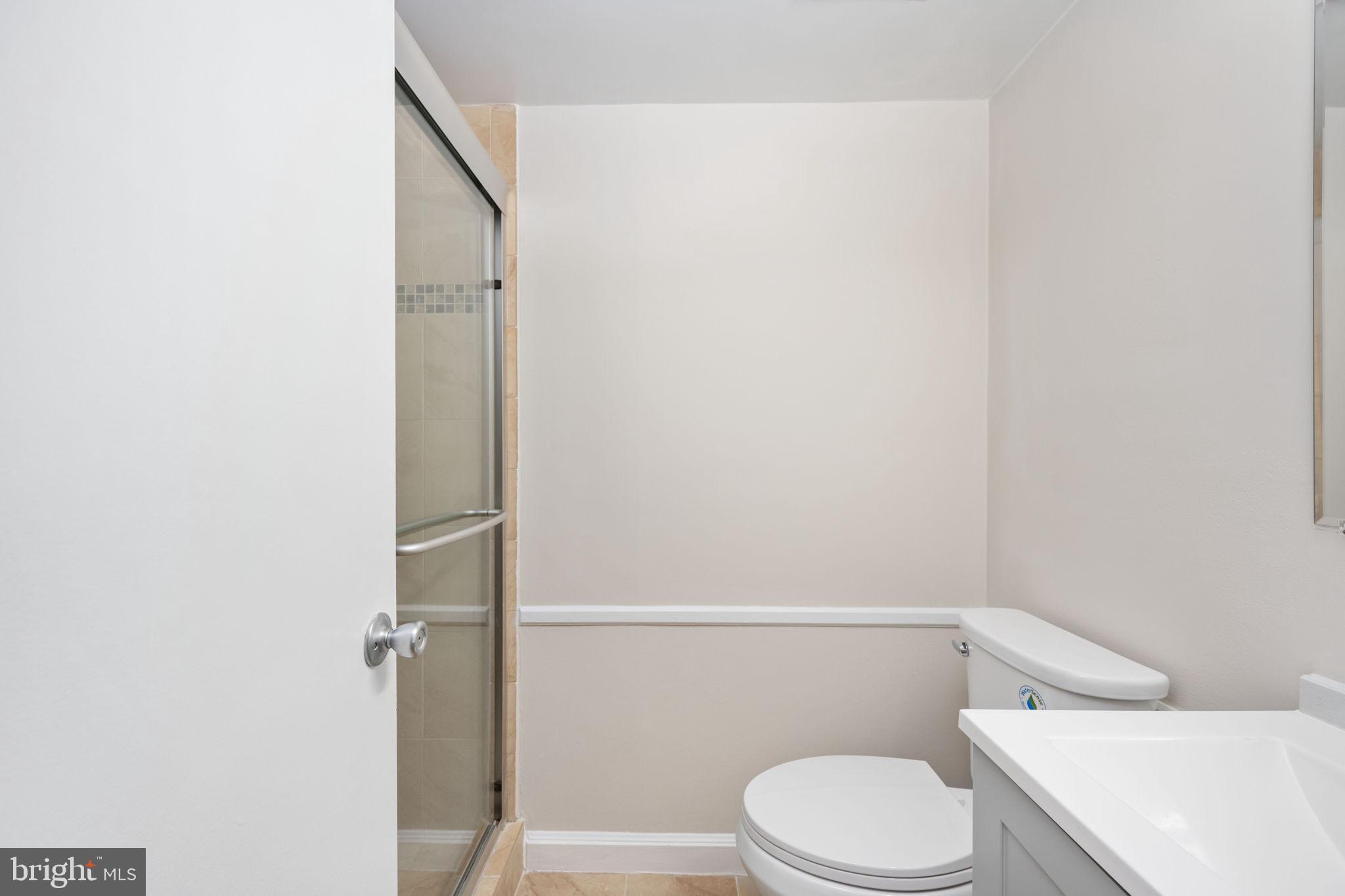 11659 Stoneview Square, Unit 11C Reston, VA 20191 - Photo 29 of 50 a white toilet sitting next to a shower