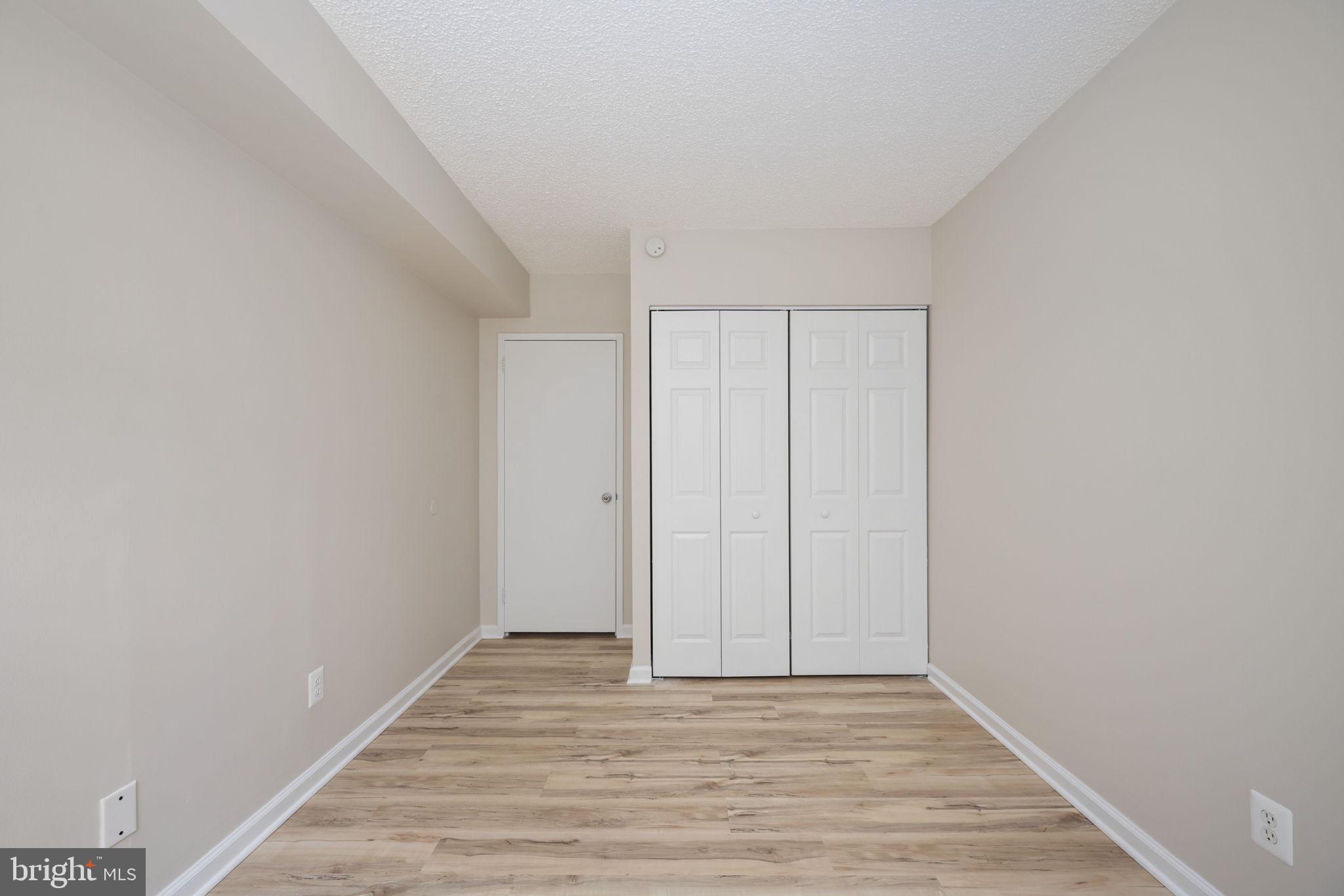 11659 Stoneview Square, Unit 11C Reston, VA 20191 - Photo 33 of 50 a view of an empty room with wooden floor