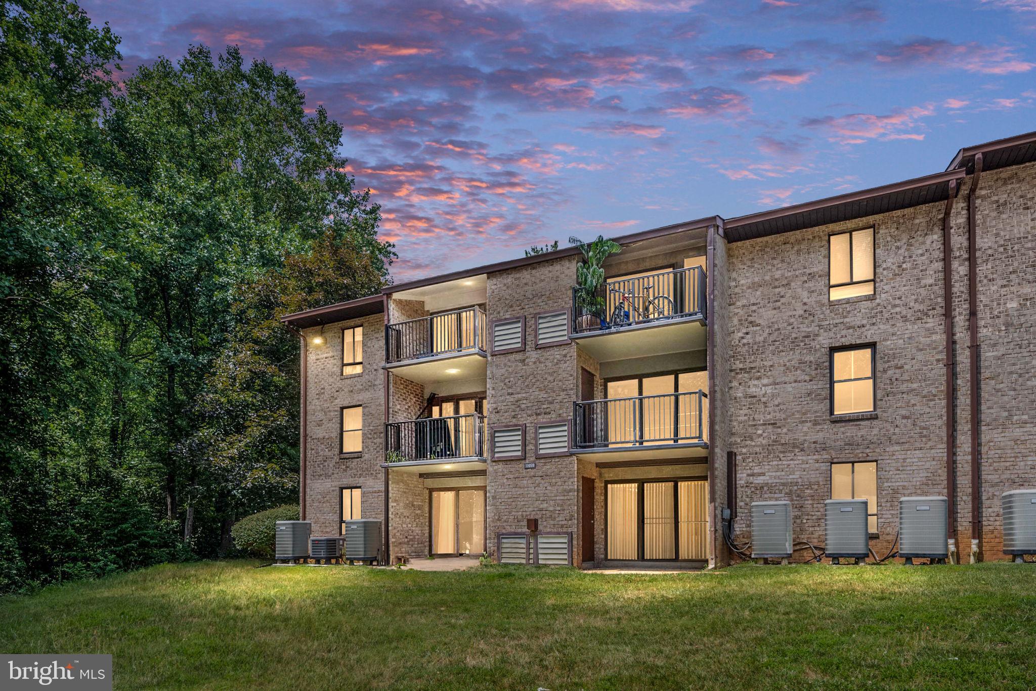 11659 Stoneview Square, Unit 11C Reston, VA 20191 - Photo 39 of 50 front view of house with a yard