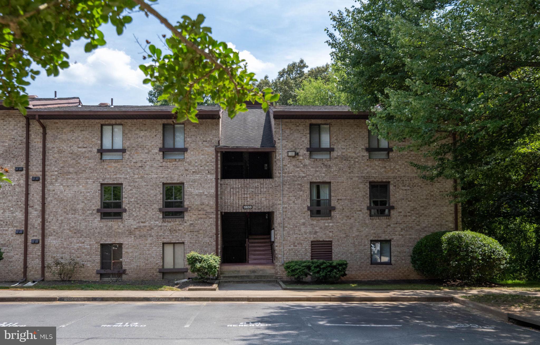 11659 Stoneview Square, Unit 11C Reston, VA 20191 - Photo 41 of 50 a front view of a house with a yard