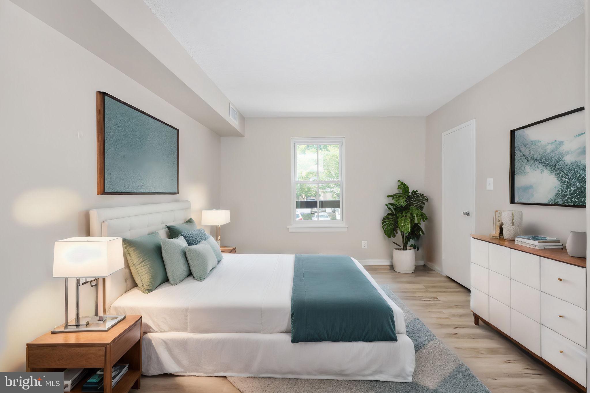 11659 Stoneview Square, Unit 11C Reston, VA 20191 - Photo 5 of 50 a bedroom with a bed and a flat screen tv