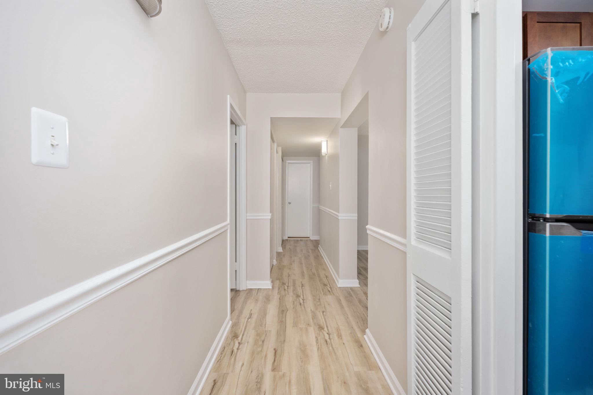 11659 Stoneview Square, Unit 11C Reston, VA 20191 - Photo 8 of 50 a view of a hallway with wooden floor