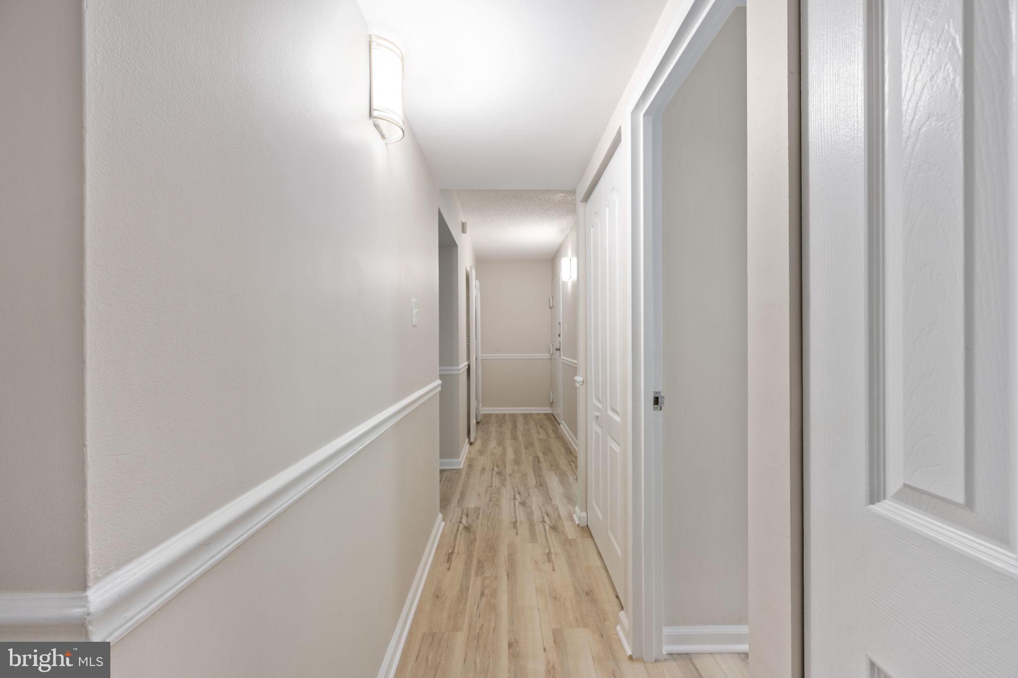 11659 Stoneview Square, Unit 11C Reston, VA 20191 - Photo 9 of 50 a view of a hallway with wooden floor