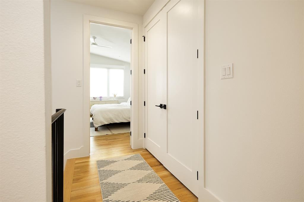 1844 Mecca Street Dallas, TX 75206 - Photo 25 of 33 Corridor with laundry closest leading into primary bedroom