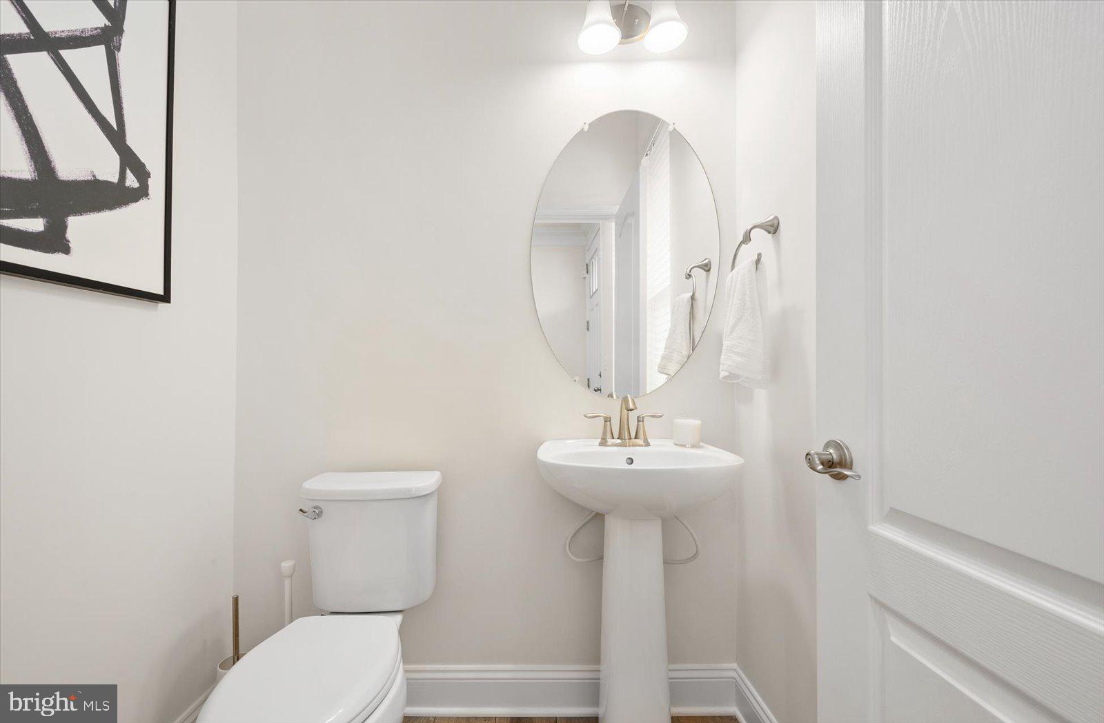 38057 Cross Gate Road Millville, DE 19967 - Photo 20 of 86 a bathroom with a toilet sink and mirror
