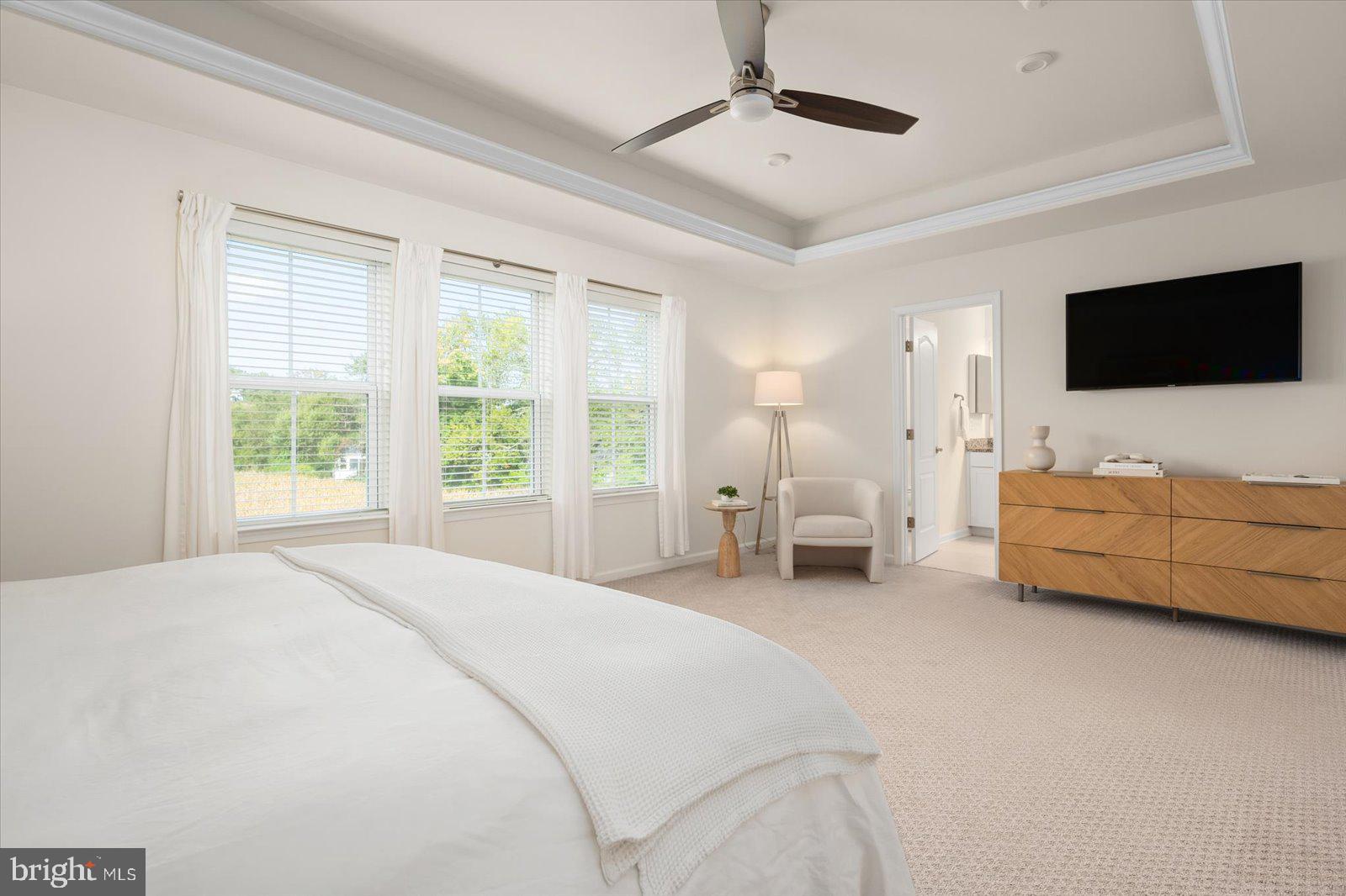 38057 Cross Gate Road Millville, DE 19967 - Photo 26 of 86 a spacious bedroom with a bed and a flat screen tv