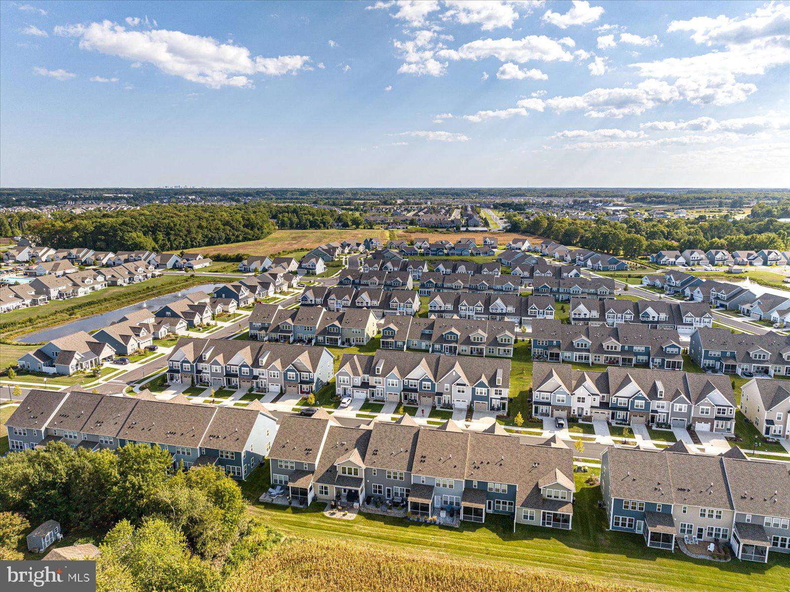 38057 Cross Gate Road Millville, DE 19967 - Photo 58 of 86 an aerial view of a city with lots of residential buildings ocean and mountain view in back